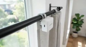 A smart curtain opener for renters no drilling fitted to a living room window pole in a London flat